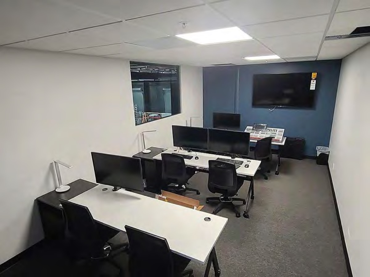 The control room with switching workstations and a window onto the stage