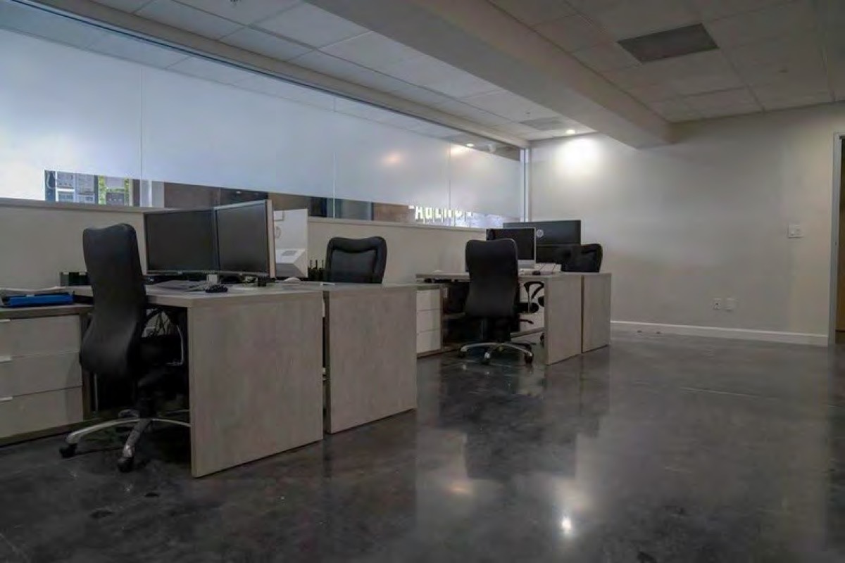 Open office with four workstations and dual monitors