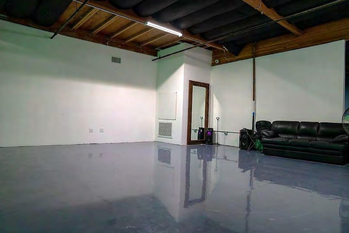 The staging area with a full-length mirror and a sofa