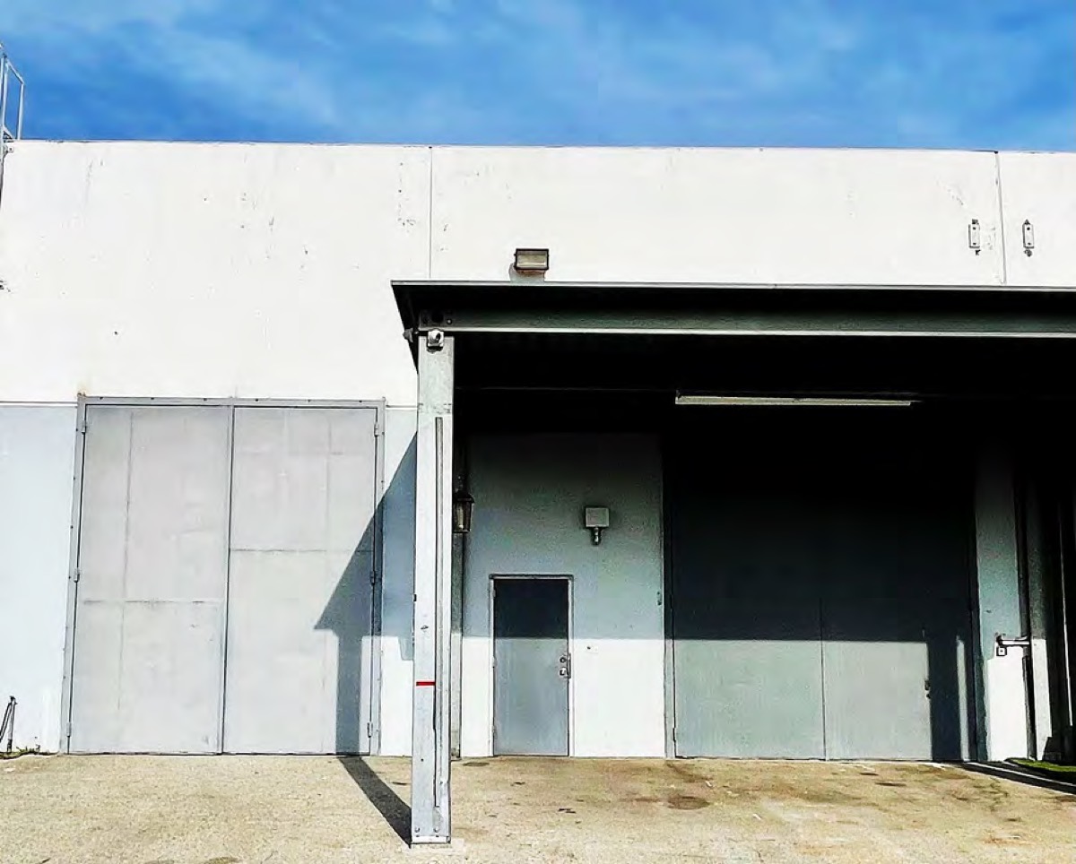 The two loading bays on the side of the building, one under an awning