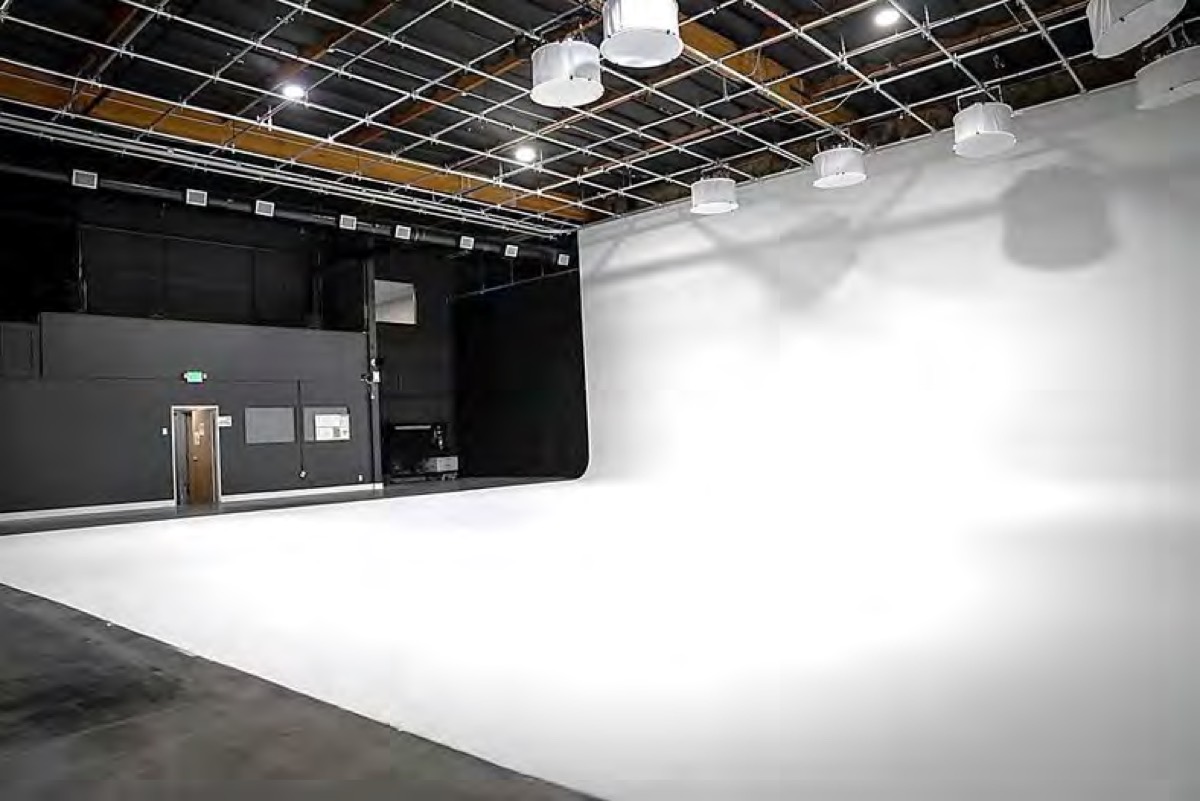 Stage 1 from the perimeter, showing the black walls and roll-up doors beside the cyc